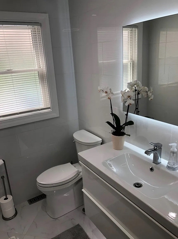 6 Temple Street Framingham, MA 01702 - Photo 4 of 34 a bathroom with a sink a toilet and a window