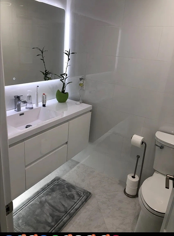 6 Temple Street Framingham, MA 01702 - Photo 7 of 34 a bathroom with a sink and toilet