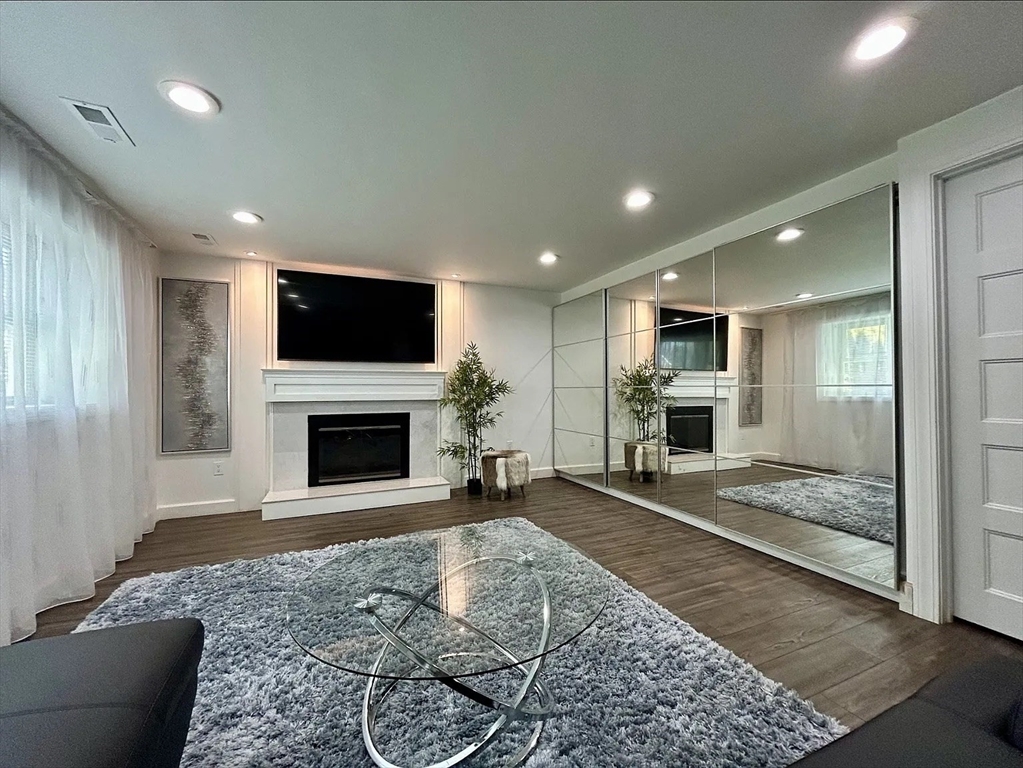 6 Temple Street Framingham, MA 01702 - Photo 8 of 34 a living room with furniture a fireplace and a flat screen tv