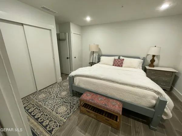 a bedroom with a bed and a rug