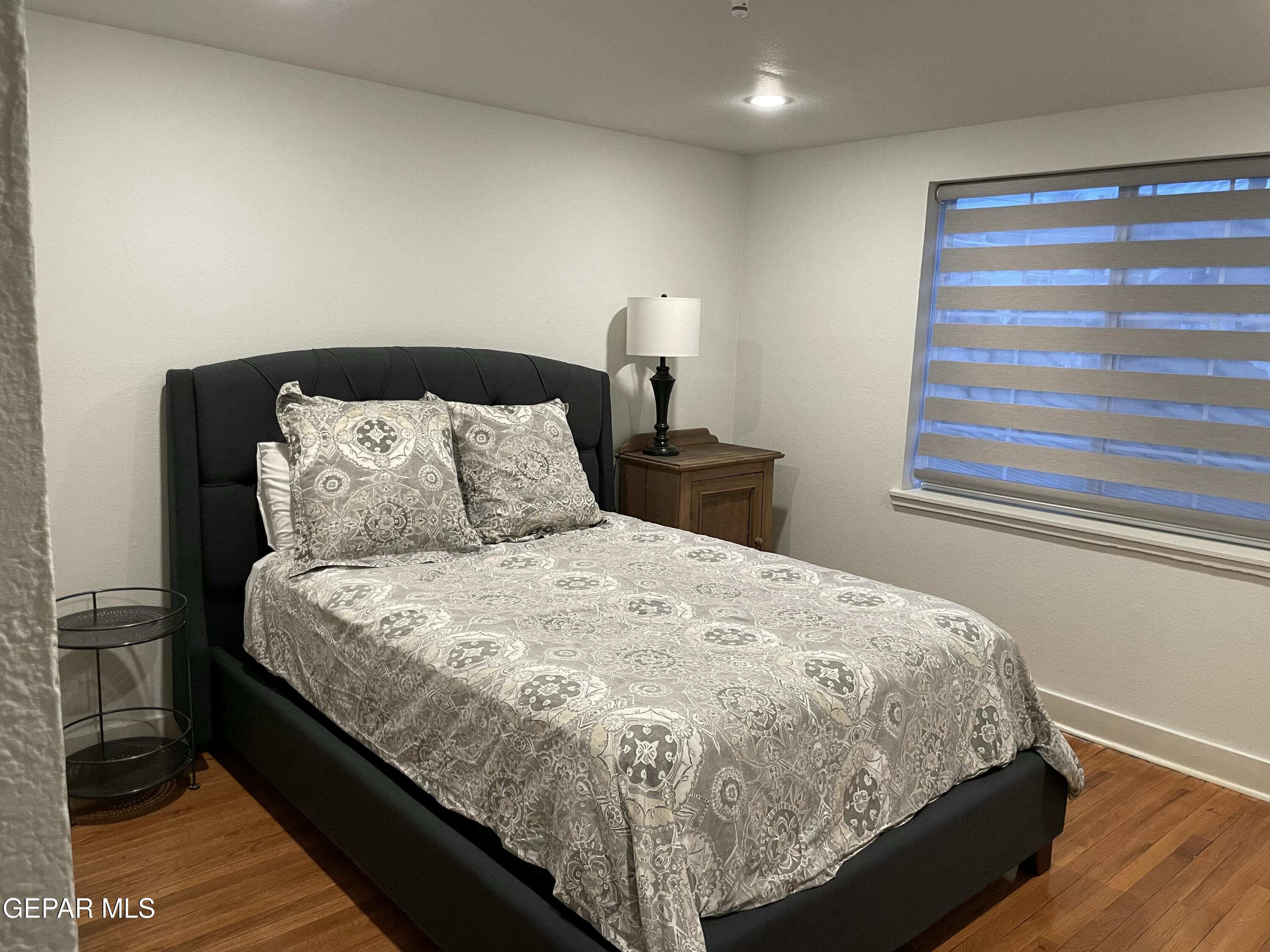 1415 North Ochoa Street, Unit B El Paso, TX 79902 - Photo 15 of 17 a large bed sitting in a bedroom next to a window