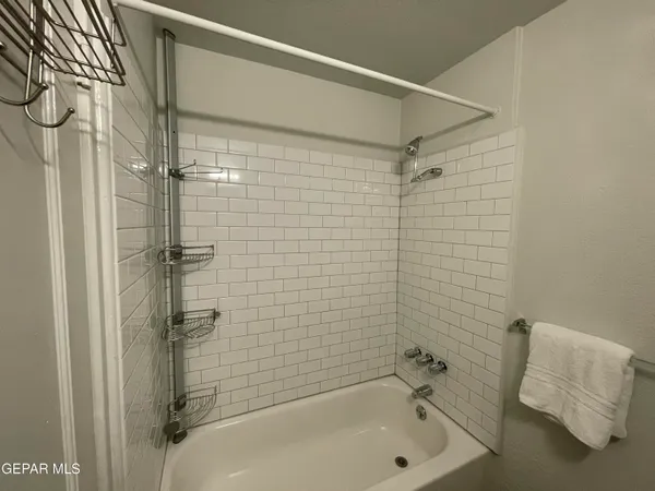 a bathroom with a bathtub and shower