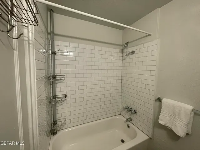 a view of a street with cars on both side of the road