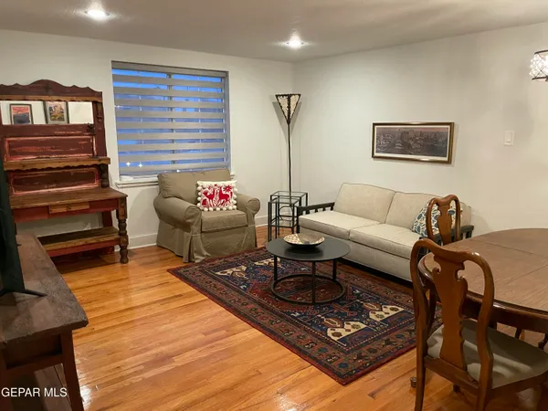 a living room with furniture and a rug