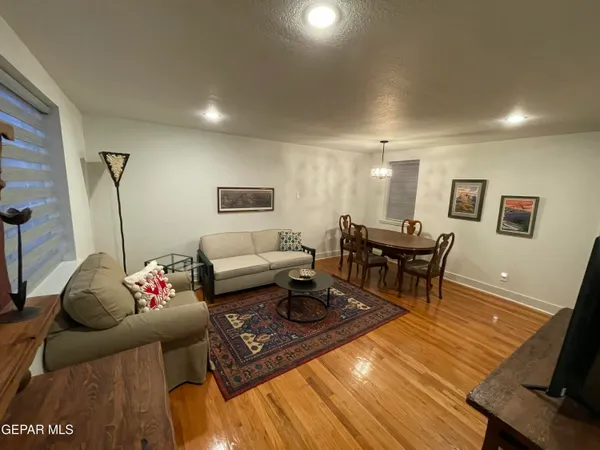 a living room with furniture and wooden floor