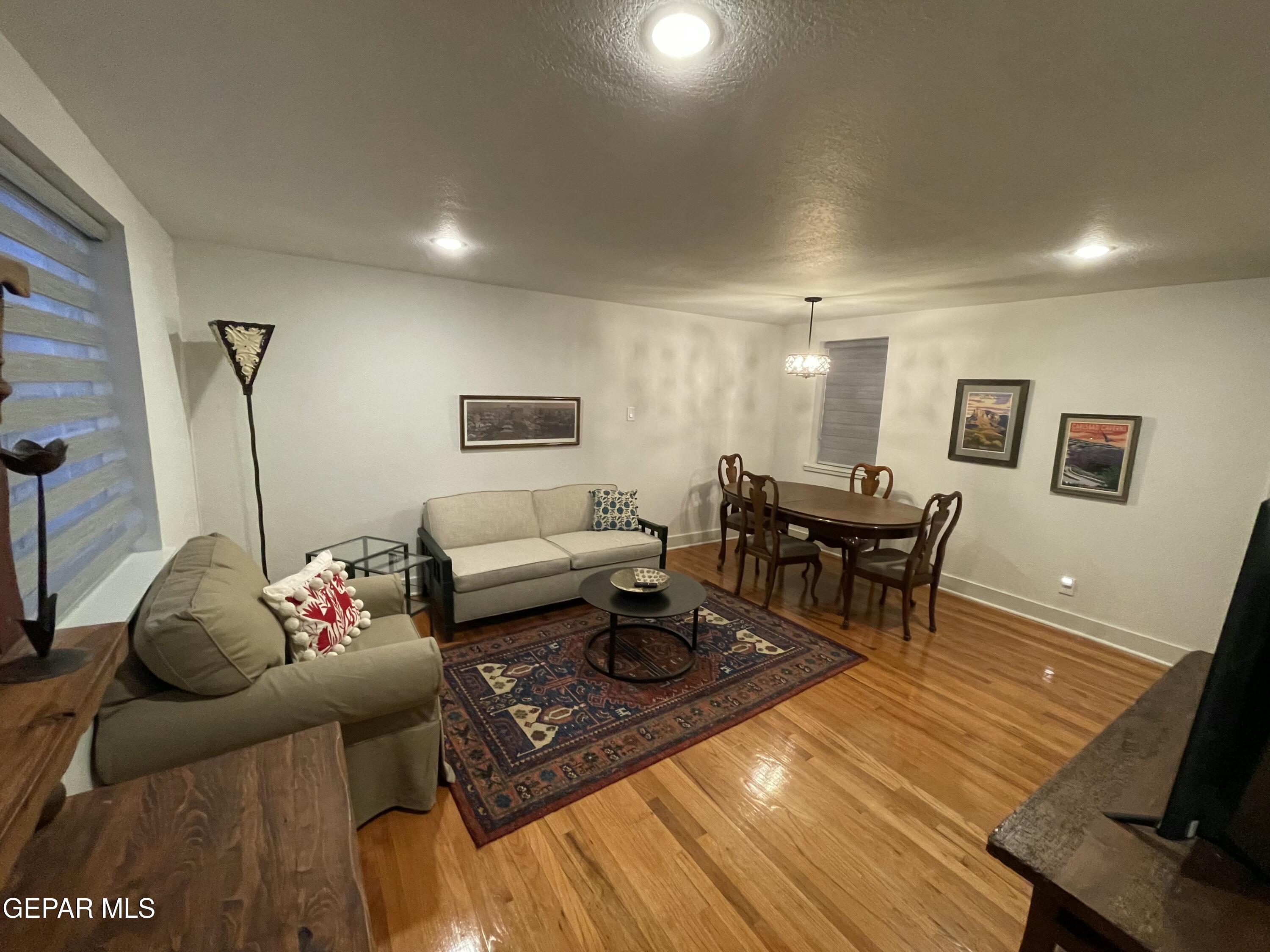1415 North Ochoa Street, Unit B El Paso, TX 79902 - Photo 6 of 17 a living room with furniture and wooden floor