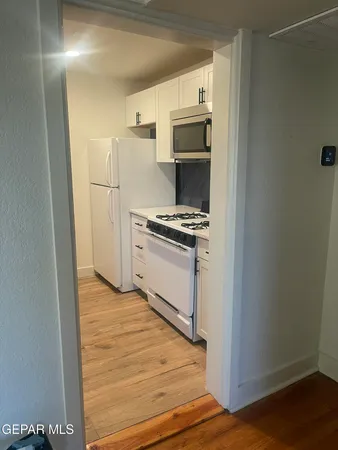 a kitchen with a stove and a refrigerator