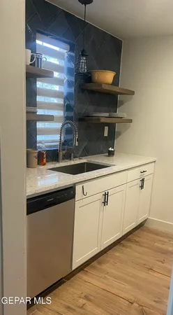 a kitchen with a sink and cabinets