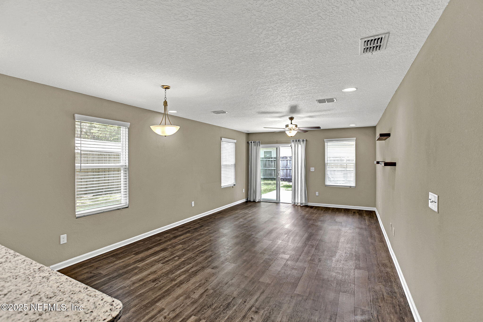 1206 Murray Drive Jacksonville, FL 32205 - Photo 12 of 23 a view of an empty room with wooden floor and a window