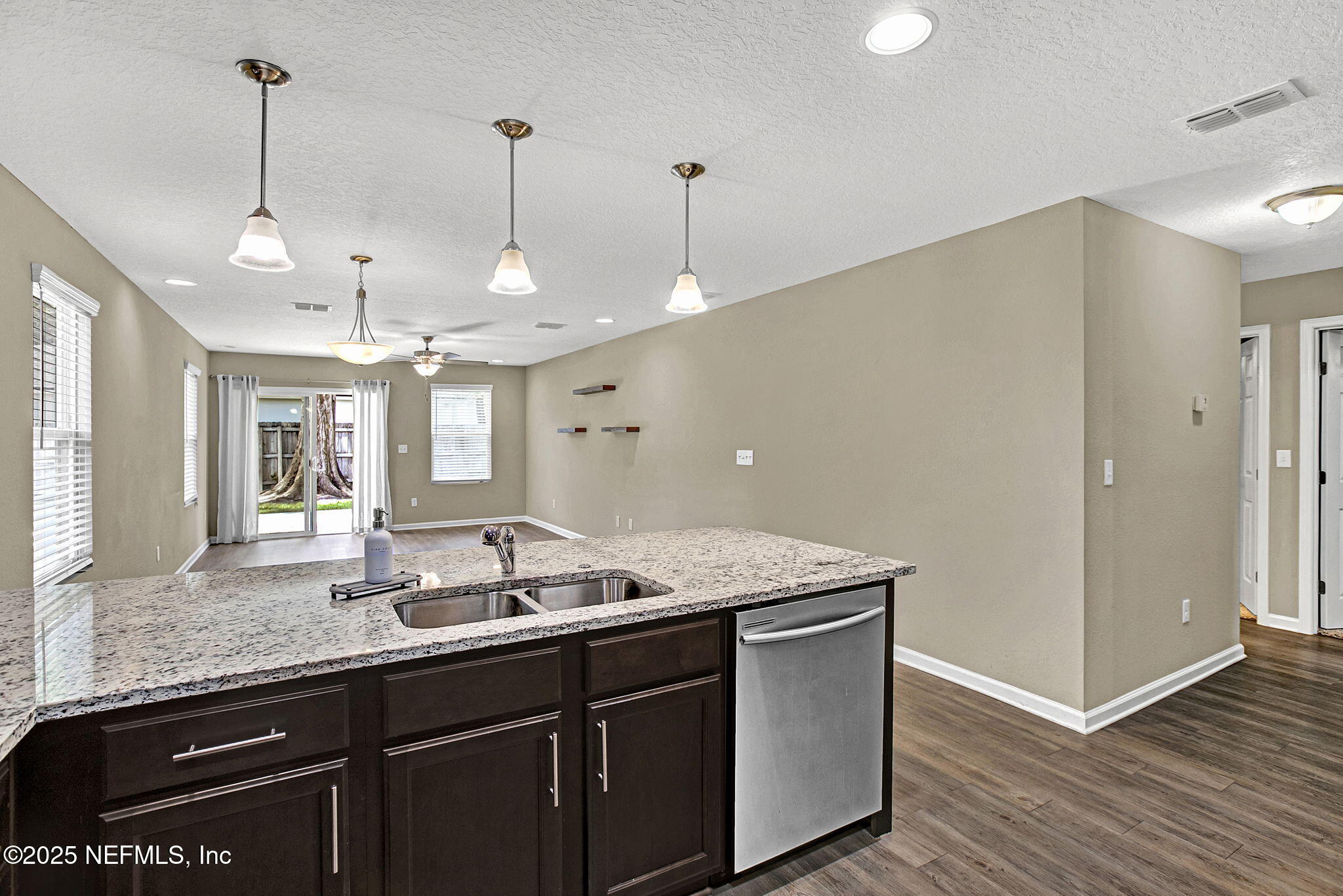 1206 Murray Drive Jacksonville, FL 32205 - Photo 15 of 23 a kitchen with granite countertop a sink cabinets and wooden floor