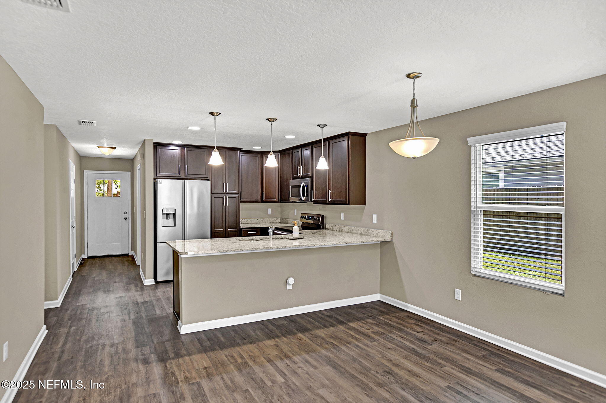 1206 Murray Drive Jacksonville, FL 32205 - Photo 9 of 23 a view of kitchen with refrigerator microwave and stove