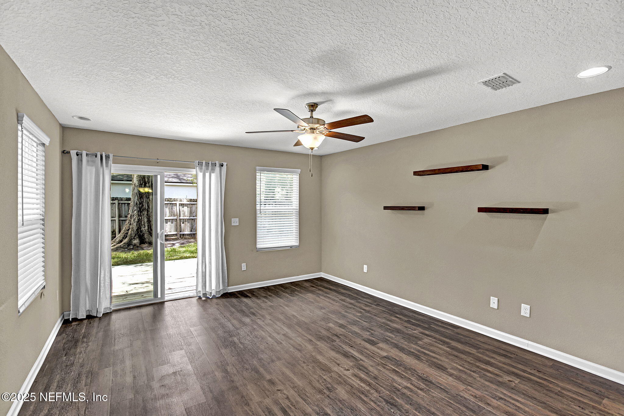 1206 Murray Drive Jacksonville, FL 32205 - Photo 10 of 23 an empty room with wooden floor and windows