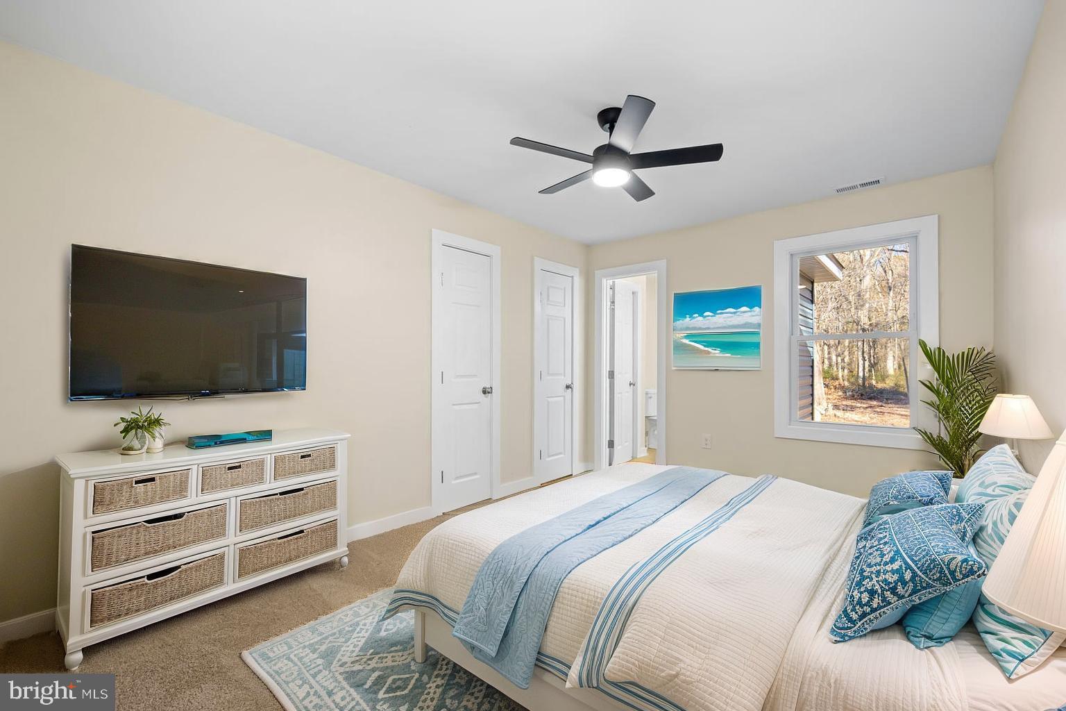 1109 Grasonville Cemetery Road Grasonville, MD 21638 - Photo 16 of 39 a bedroom with a bed and a flat screen tv