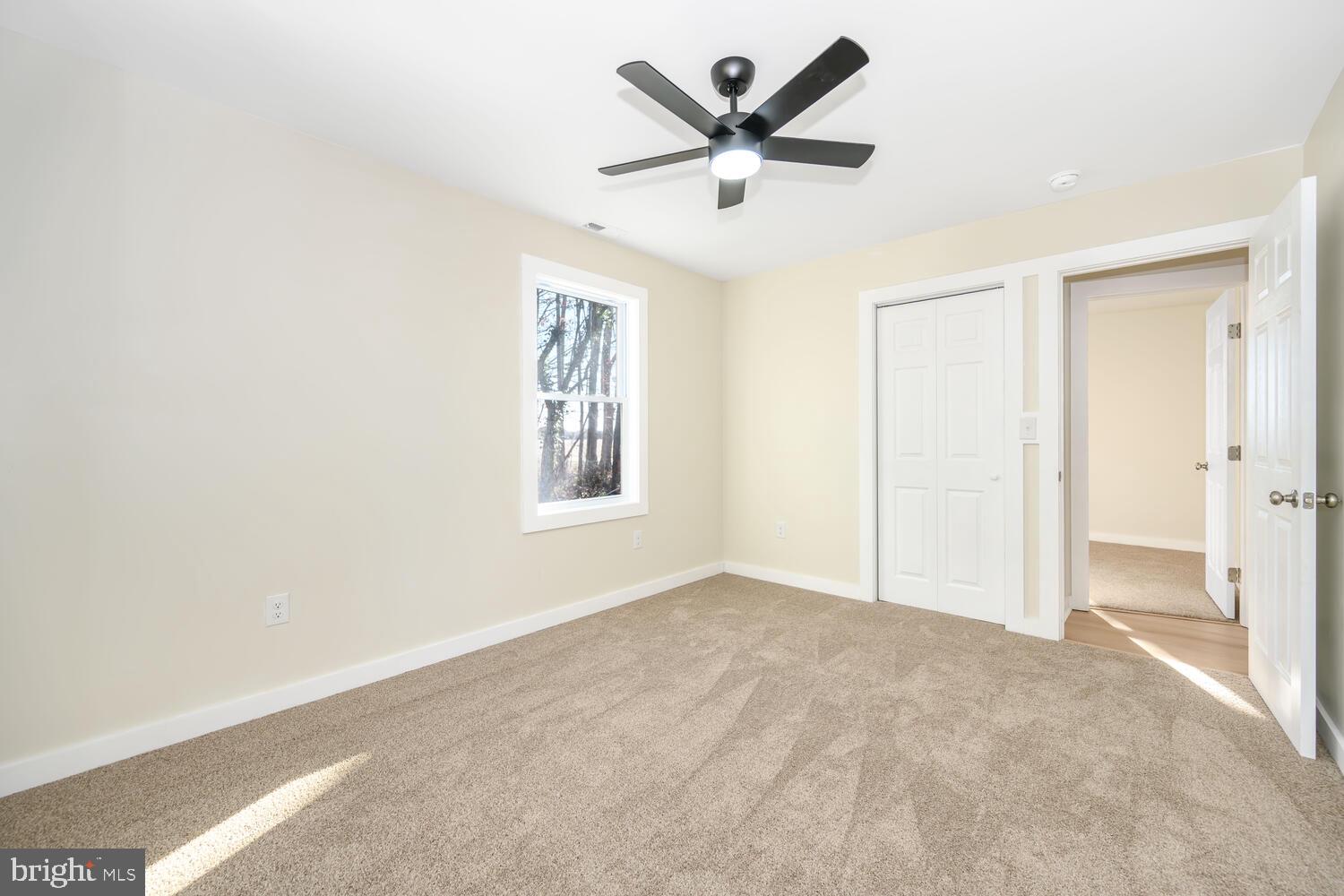 1109 Grasonville Cemetery Road Grasonville, MD 21638 - Photo 22 of 39 an empty room with a ceiling fan and a window