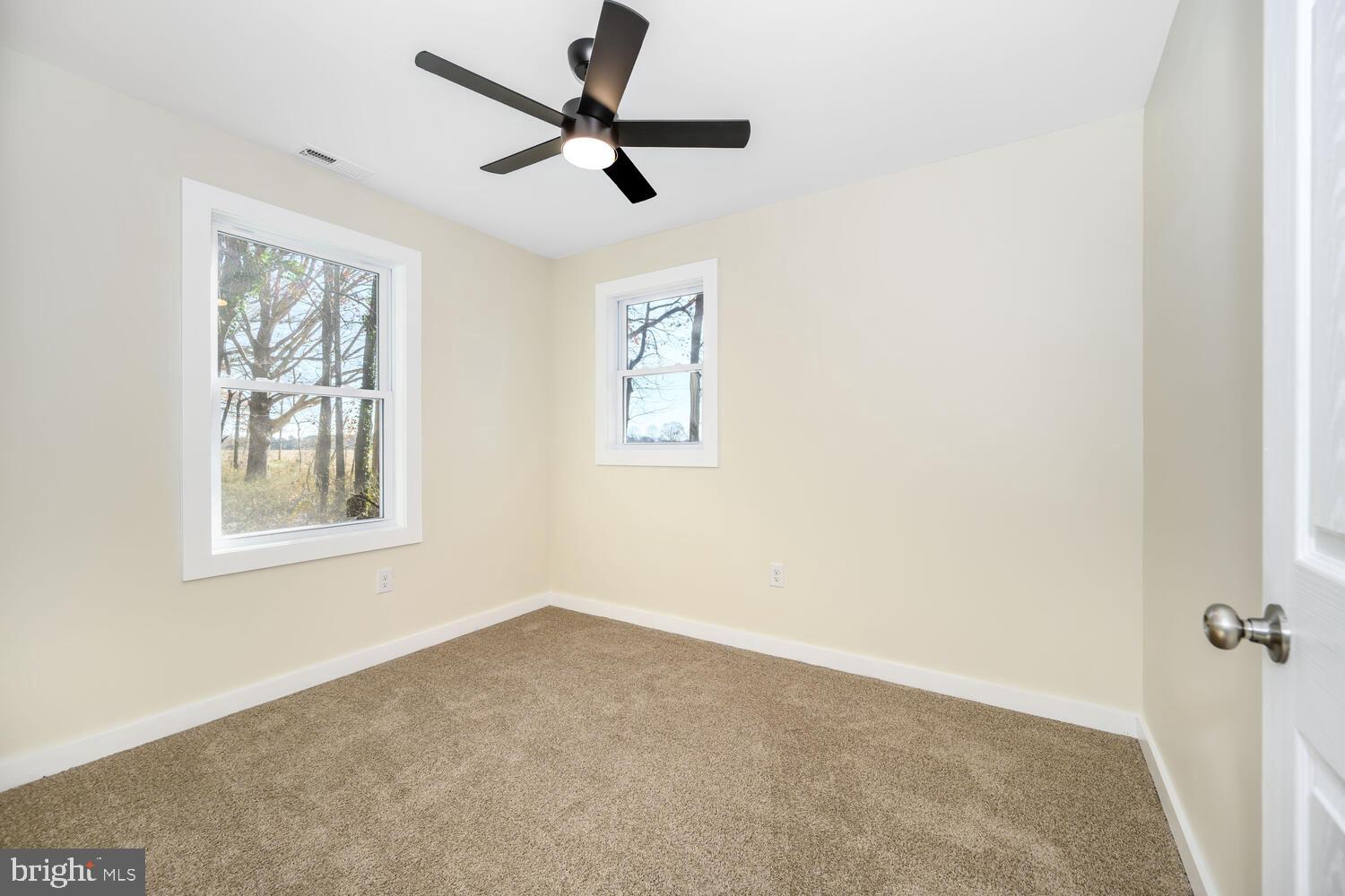 1109 Grasonville Cemetery Road Grasonville, MD 21638 - Photo 24 of 39 an empty room with a window and a fan