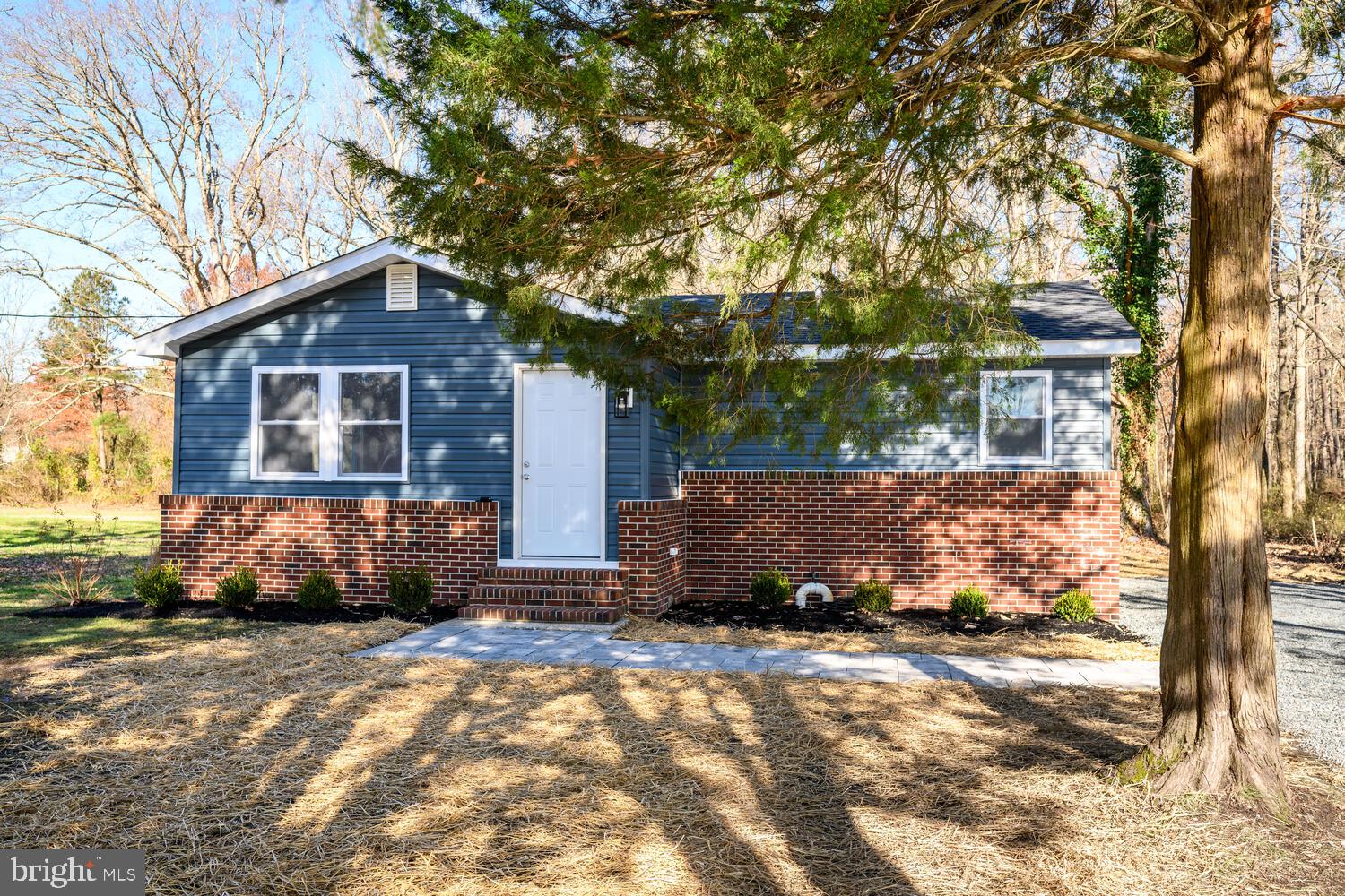 1109 Grasonville Cemetery Road Grasonville, MD 21638 - Photo 3 of 39 a front view of a house with a garden