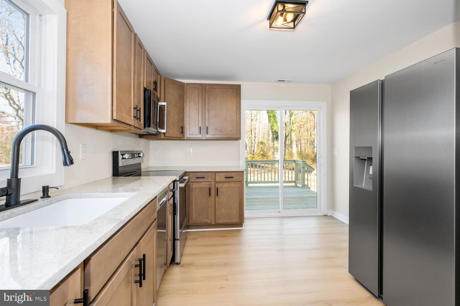 1109 Grasonville Cemetery Road Grasonville, MD 21638 - Photo 8 of 39 a kitchen with stainless steel appliances granite countertop a stove a sink and a refrigerator