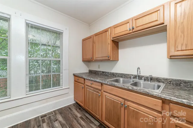 a kitchen with granite countertop a sink and a window