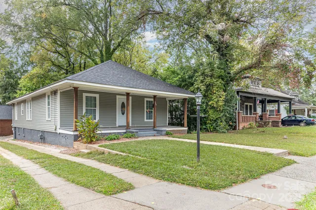 a front view of a house with a yard and porch