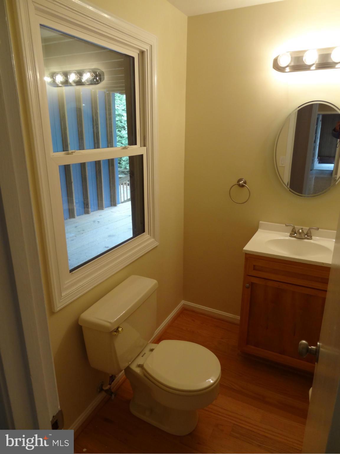2835 Hambleton Road Riva, MD 21140 - Photo 22 of 30 a bathroom with a toilet sink and mirror