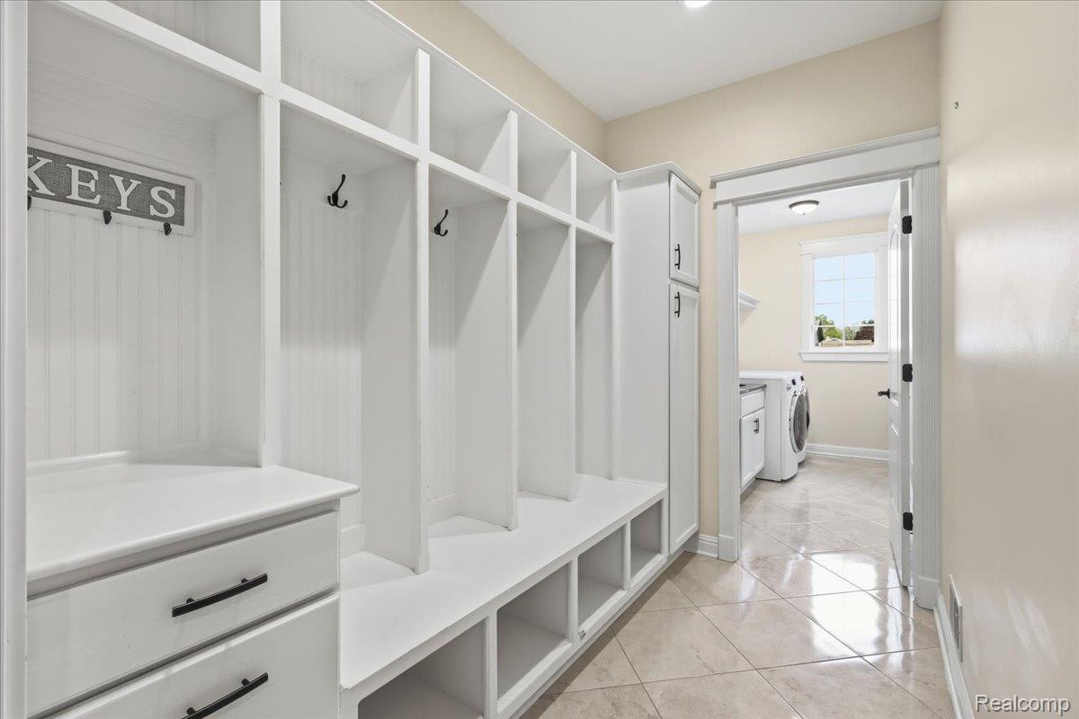 35339 West 13 Mile Road Farmington, MI 48331 - Photo 38 of 72 Mudroom featuring washing machine and clothes dryer and light tile patterned flooring