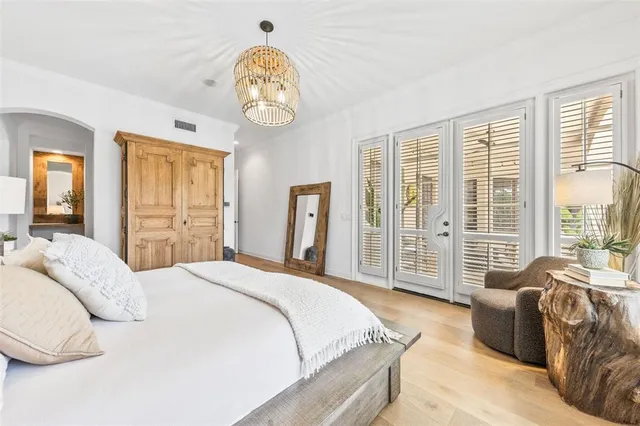 a spacious bedroom with a bed and a large window