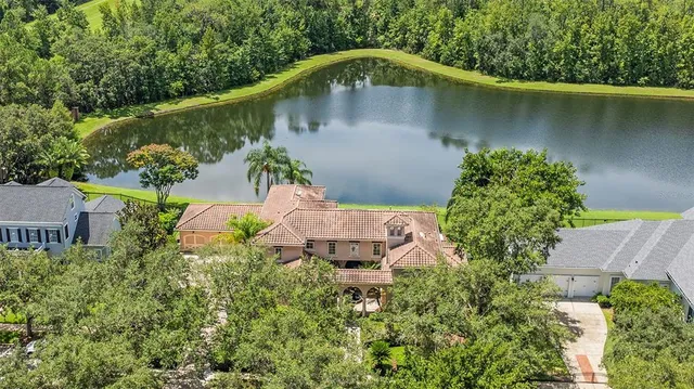 an aerial view of a house with a yard