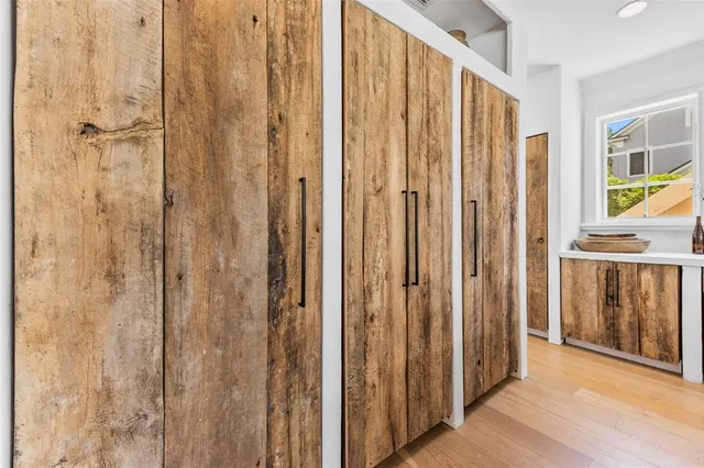 a view of a bathroom with shower wooden floor and front door