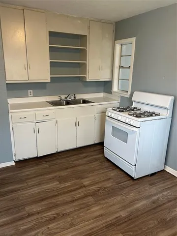 a kitchen with stainless steel appliances granite countertop a stove and a sink