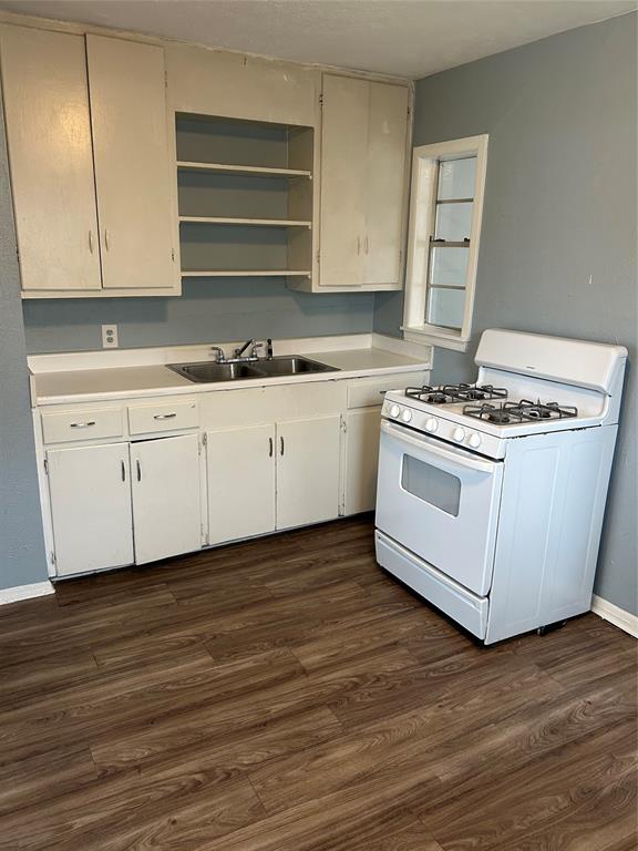 409 Wildwood Drive Mesquite, TX 75149 - Photo 3 of 9 a kitchen with stainless steel appliances granite countertop a stove and a sink