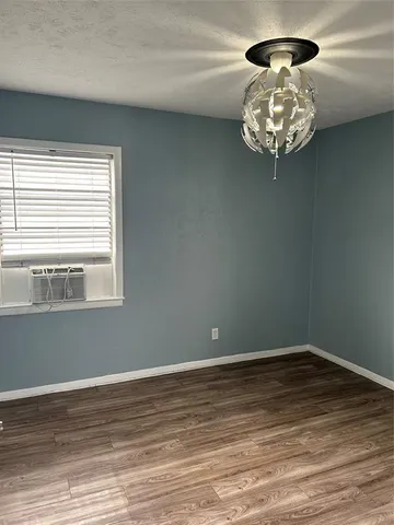 a view of a chandelier fan and wooden floor