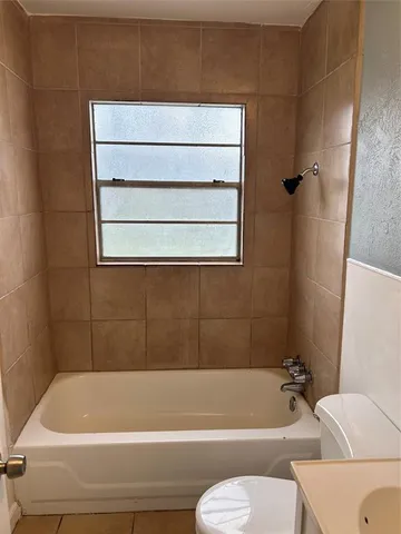 a bathroom with a bathtub and a toilet