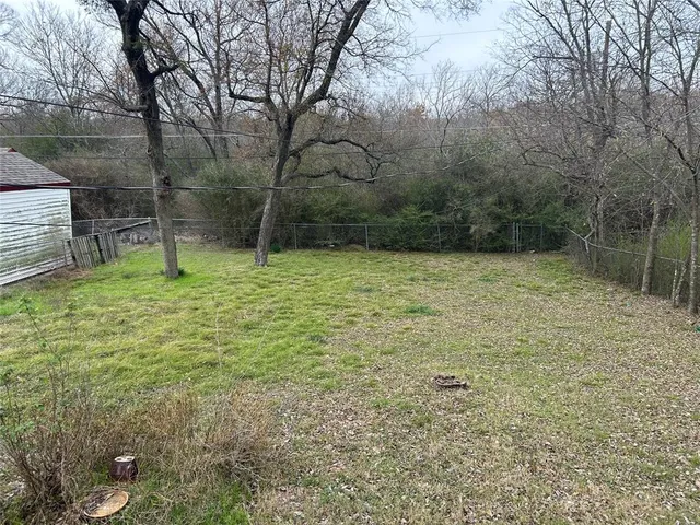 a small pool with trees in the background