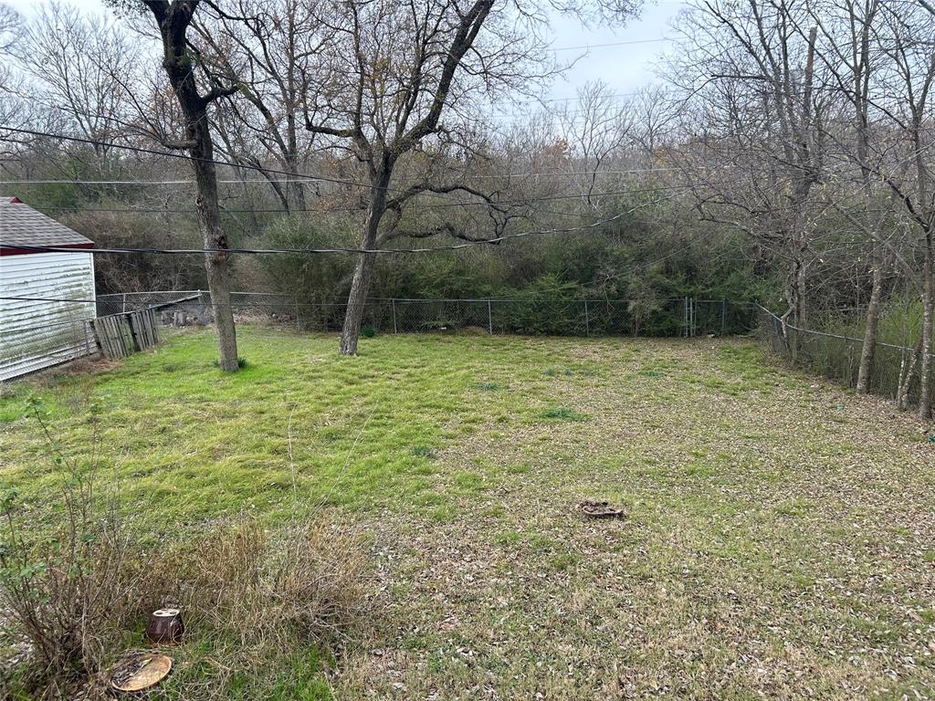 409 Wildwood Drive Mesquite, TX 75149 - Photo 8 of 9 a small pool with trees in the background