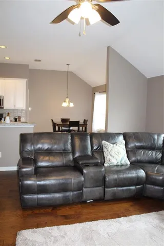 a living room with furniture and a chandelier