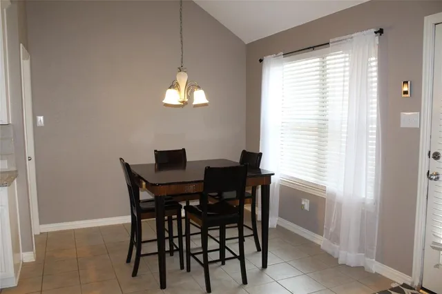 a view of a dining room with furniture and a chandelier