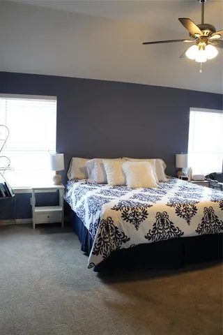 a bedroom with a bed dresser and a couch