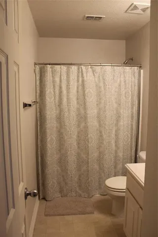 a bathroom with a toilet and shower