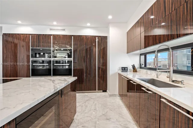 a kitchen with kitchen island a sink and wooden cabinets