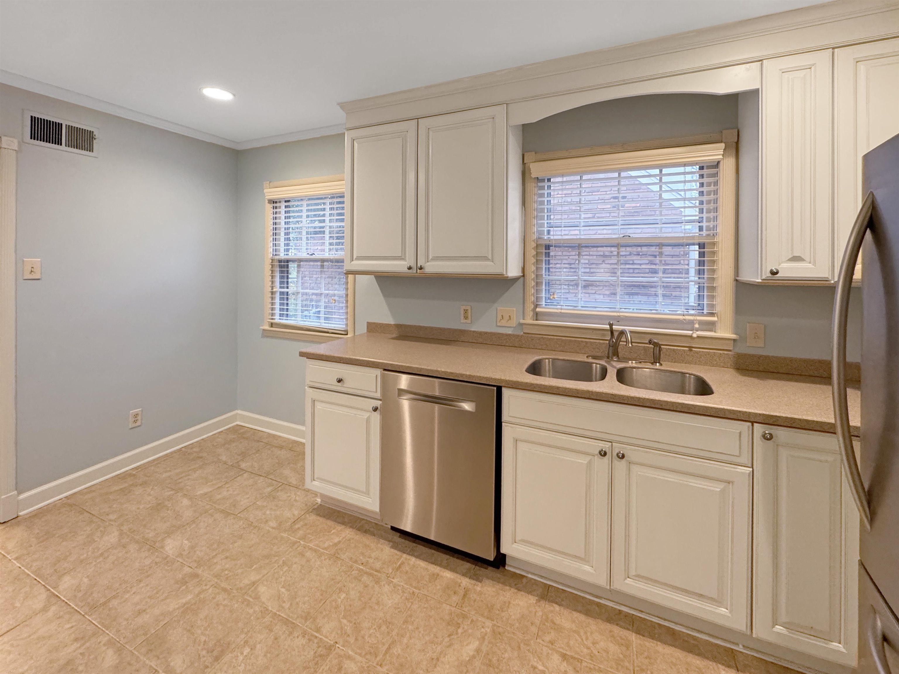 407 Meadvale Road Memphis, TN 38120 - Photo 14 of 37 a kitchen with stainless steel appliances granite countertop a sink and a white cabinets