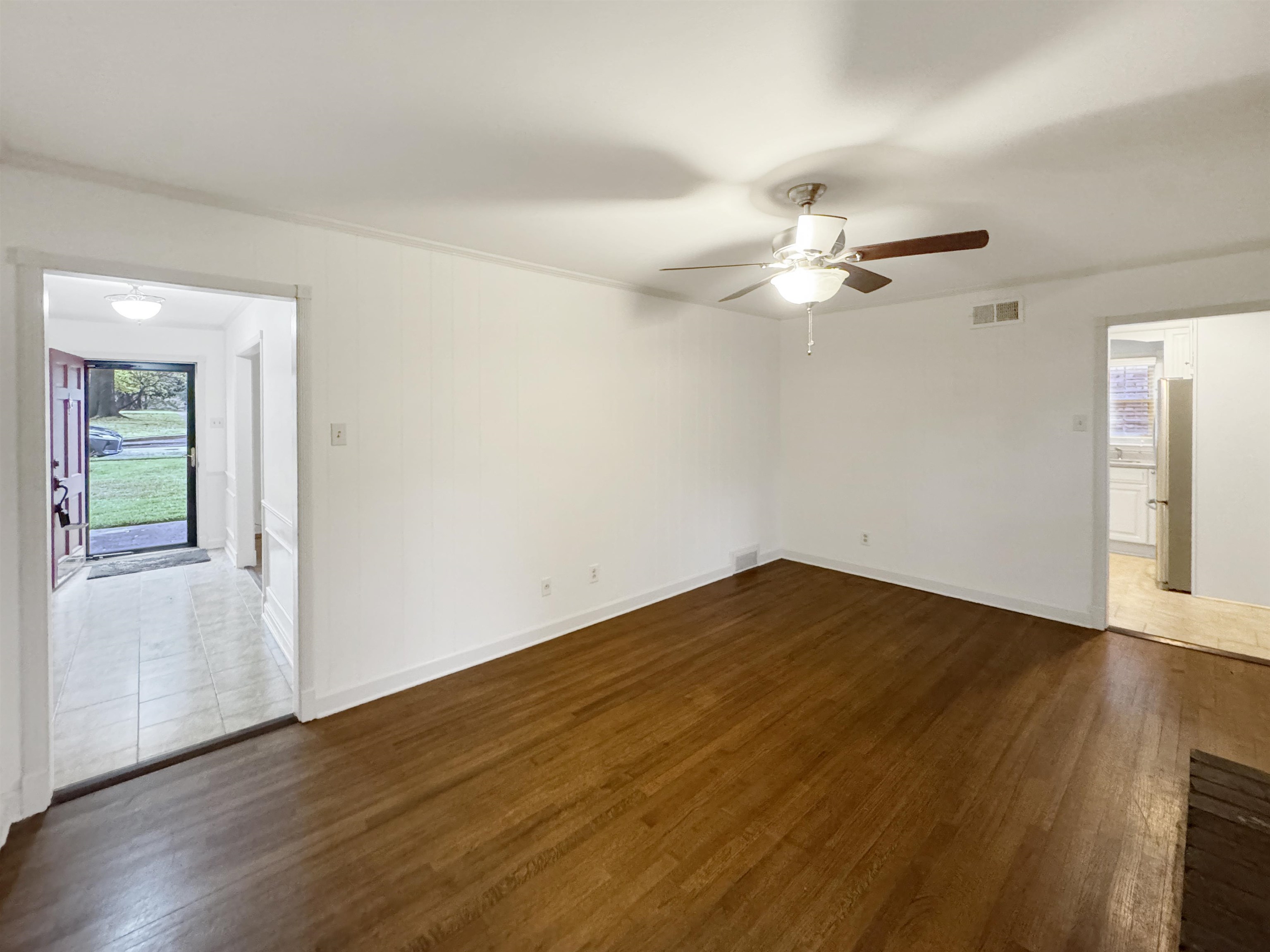 407 Meadvale Road Memphis, TN 38120 - Photo 18 of 37 a view of a room with wooden floor and a ceiling fan