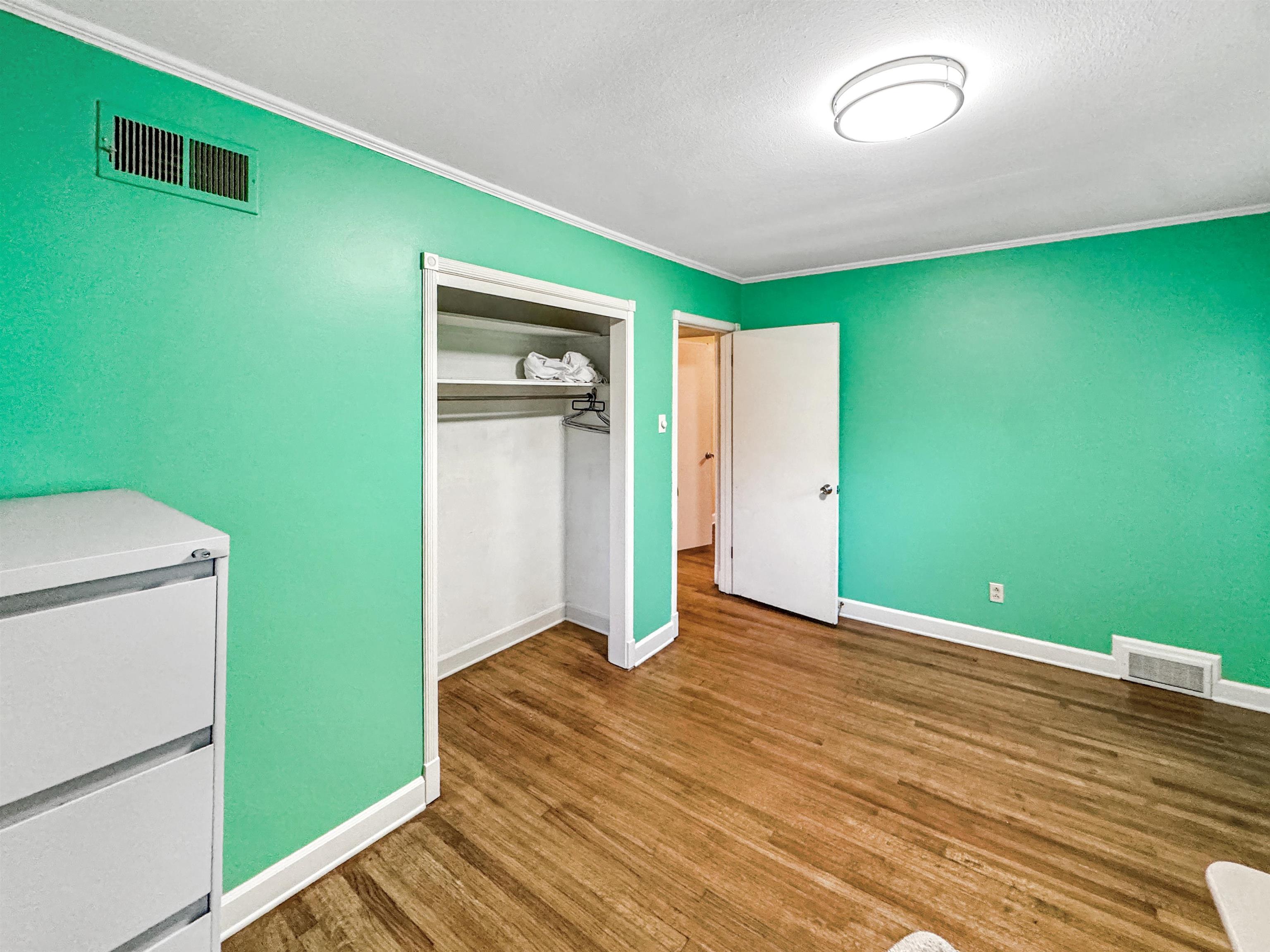 407 Meadvale Road Memphis, TN 38120 - Photo 19 of 36 a view of empty room with wooden floor