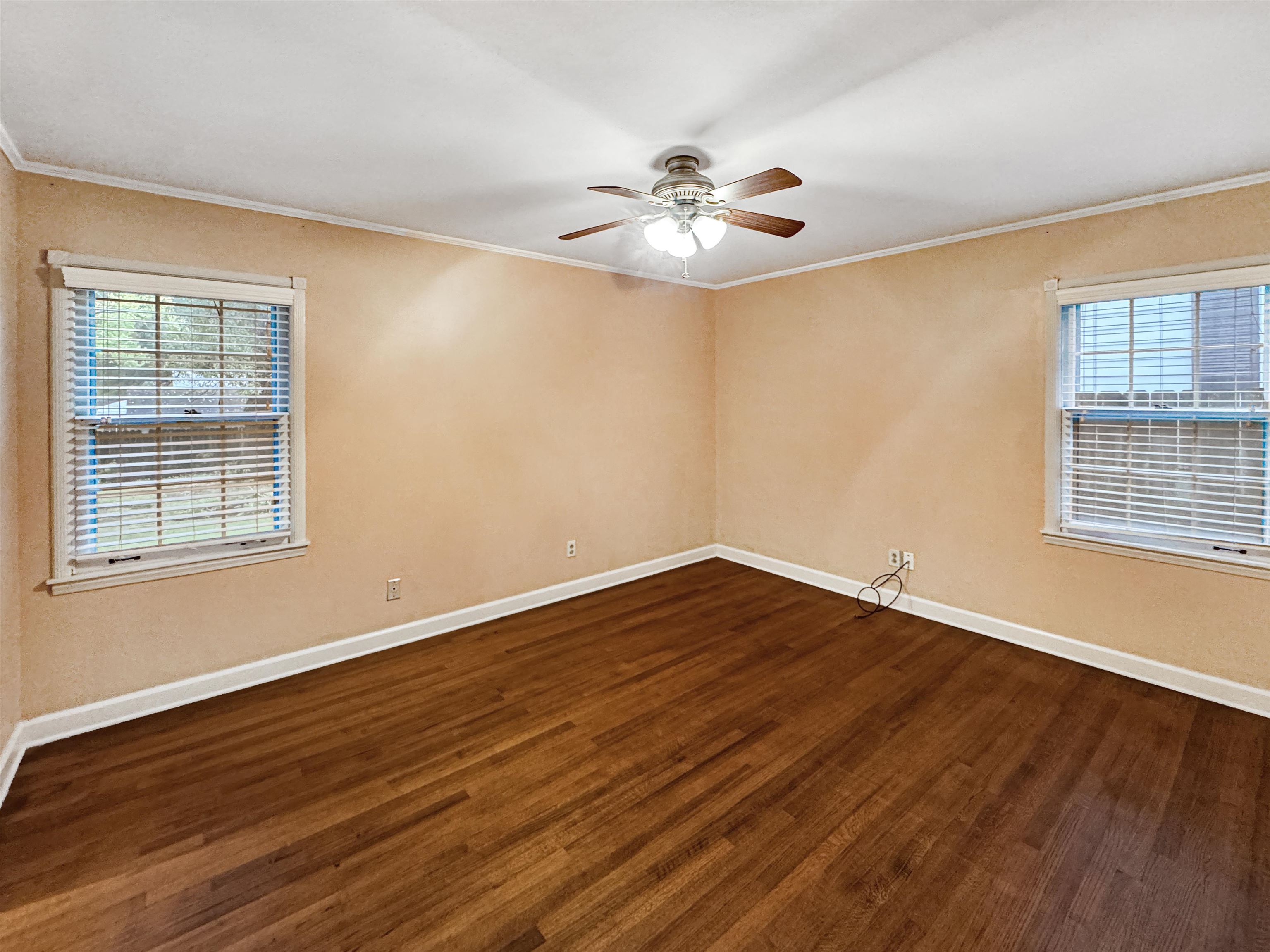 407 Meadvale Road Memphis, TN 38120 - Photo 28 of 36 a view of an empty room with wooden floor and a window