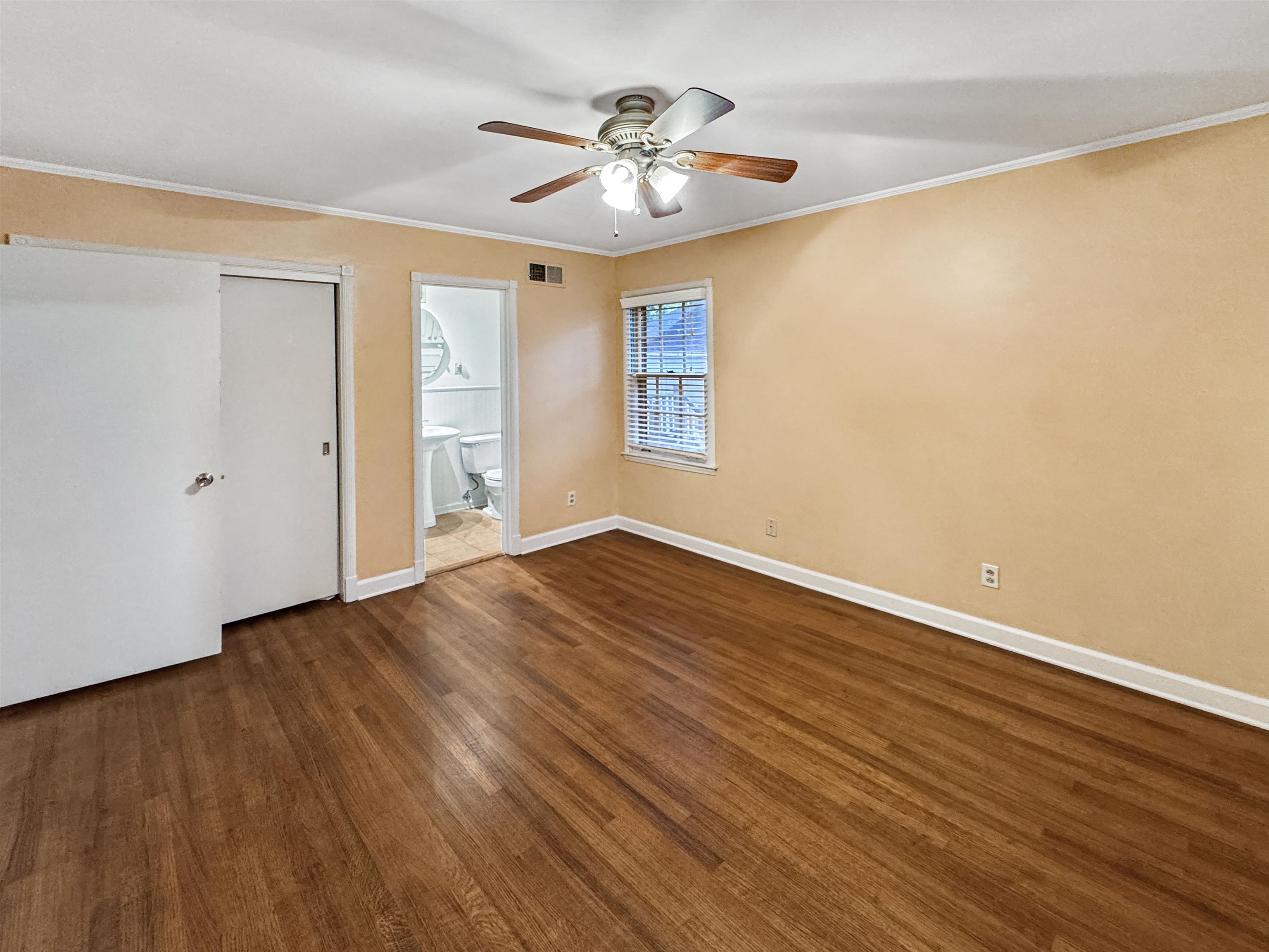 407 Meadvale Road Memphis, TN 38120 - Photo 29 of 36 a view of an empty room with window and wooden floor