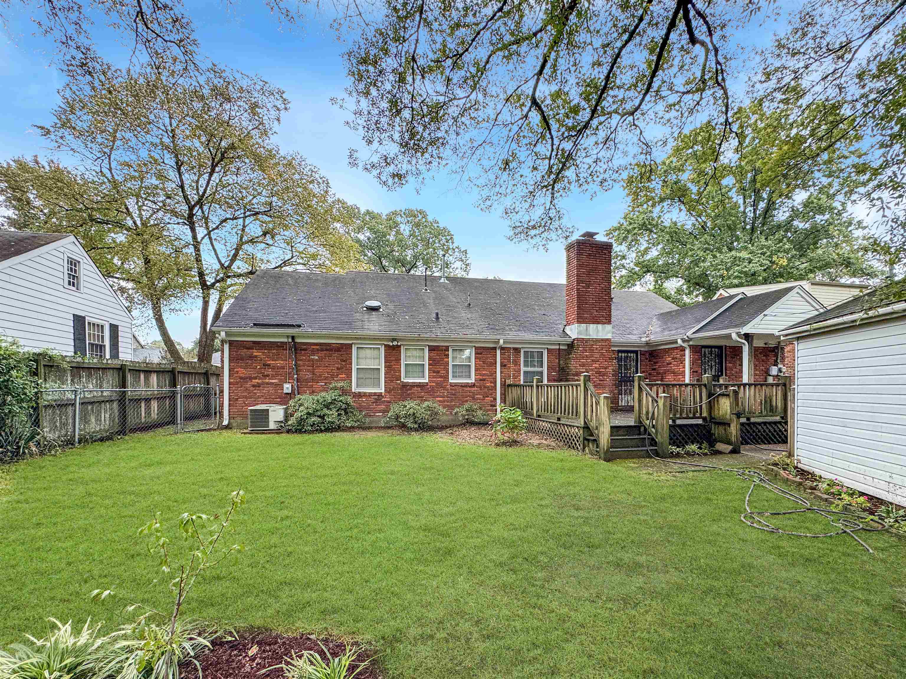 407 Meadvale Road Memphis, TN 38120 - Photo 32 of 36 a view of a yard in front of a brick house with large windows