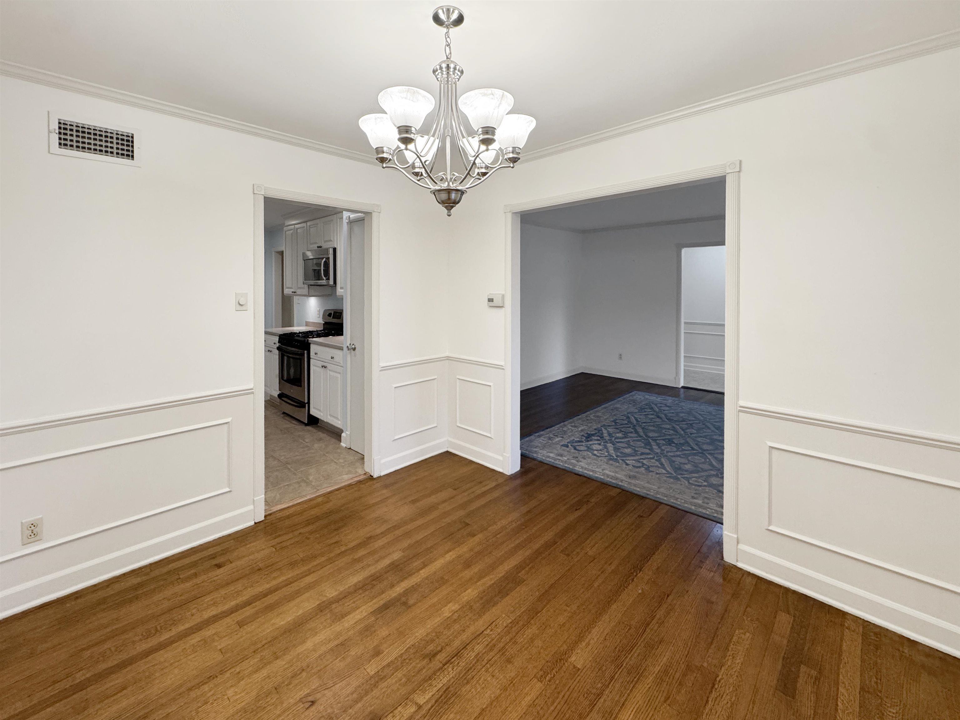 407 Meadvale Road Memphis, TN 38120 - Photo 8 of 36 a view of a room with wooden floor and chandelier