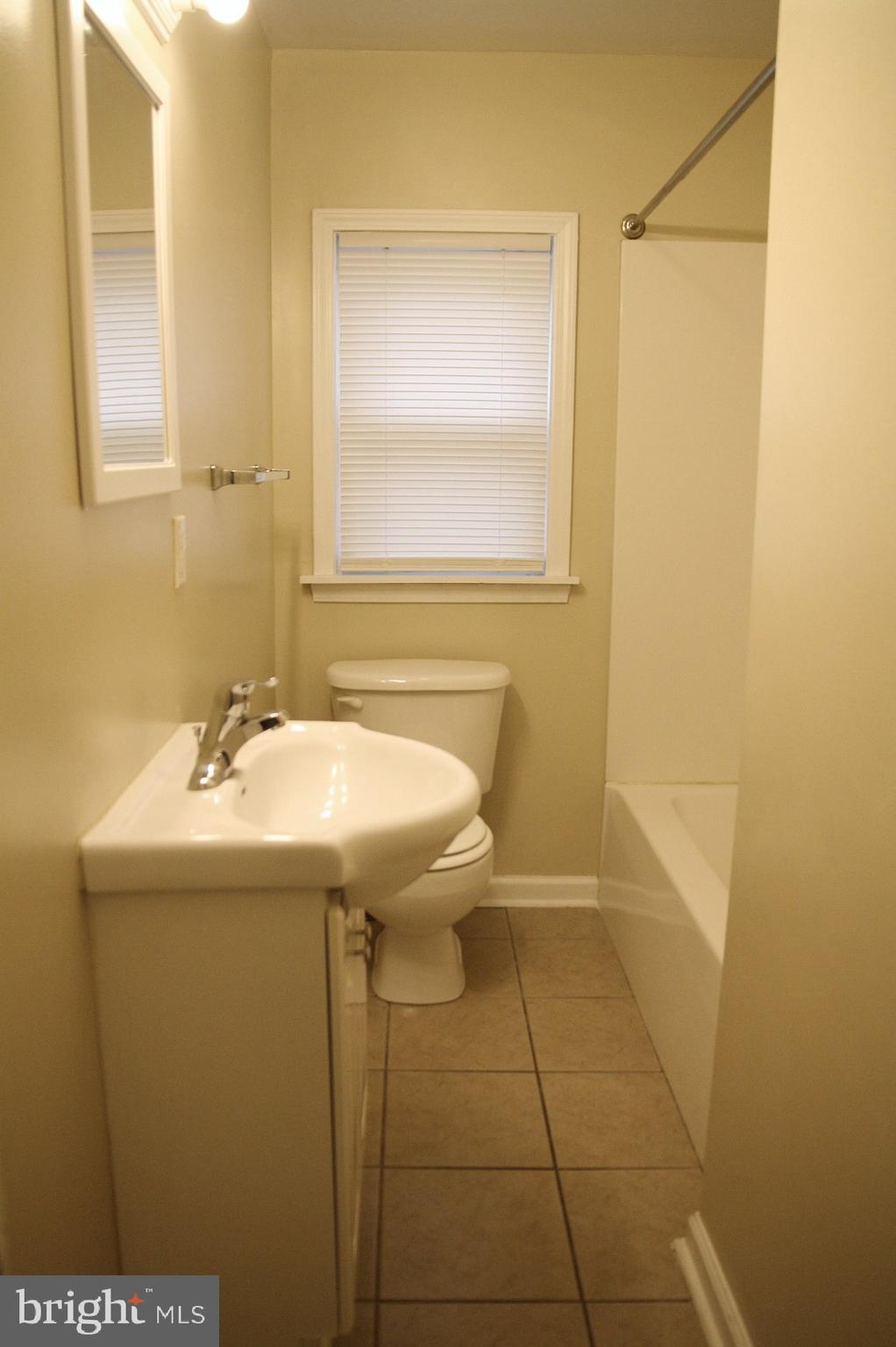 4004 Walnut Street, Unit A2 Harrisburg, PA 17109 - Photo 7 of 8 a bathroom with a sink and mirror