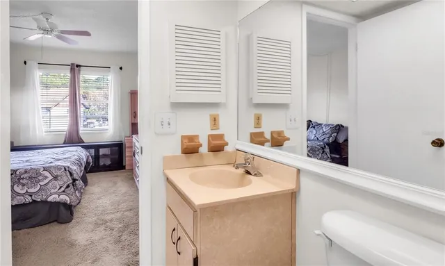 a en suite bathroom with a double vanity sink and a bathtub