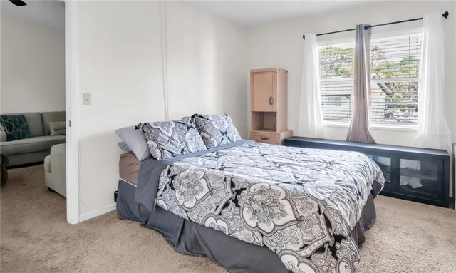 a bedroom with a bed and a window