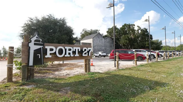 a backyard of a house with table chairs and wooden fence